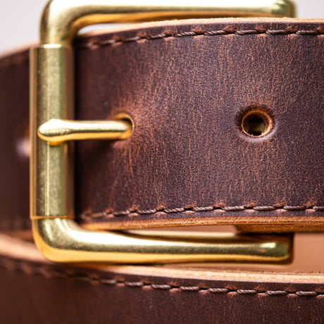 brown belt close up of brown stitching and brass roller buckle
