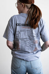 Grey T-shirt with a boot ad on it