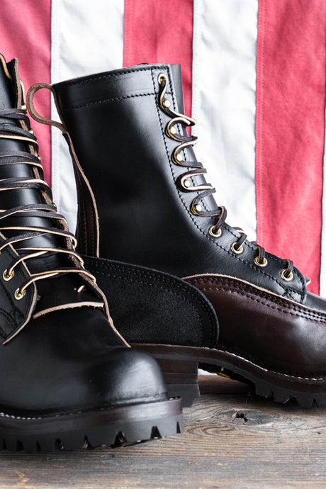 Eight tall black leather boot with rubber sole.