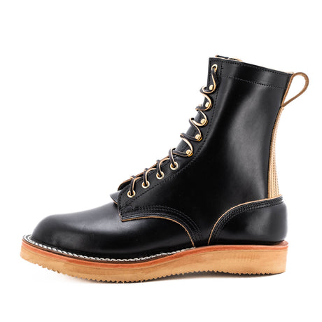 Black eight inch boot with tan backstay and vibram foam wedge sole.