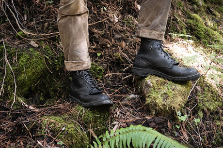 The Nicks Tactical Boot in black standing on mossy rocks
