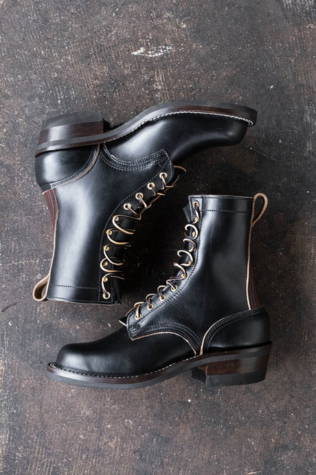 Eight inch tall black leather boot with brown backstay with a rubber sole.
