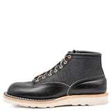 Black leather boot with white sole on a white background