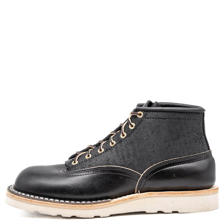 Black leather boot with white sole on a white background