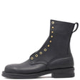 A black leather lace-up ankle boot with gold-tone metal eyelets and studs, featuring a pull loop and a low block heel, shown from a side profile on a white background.